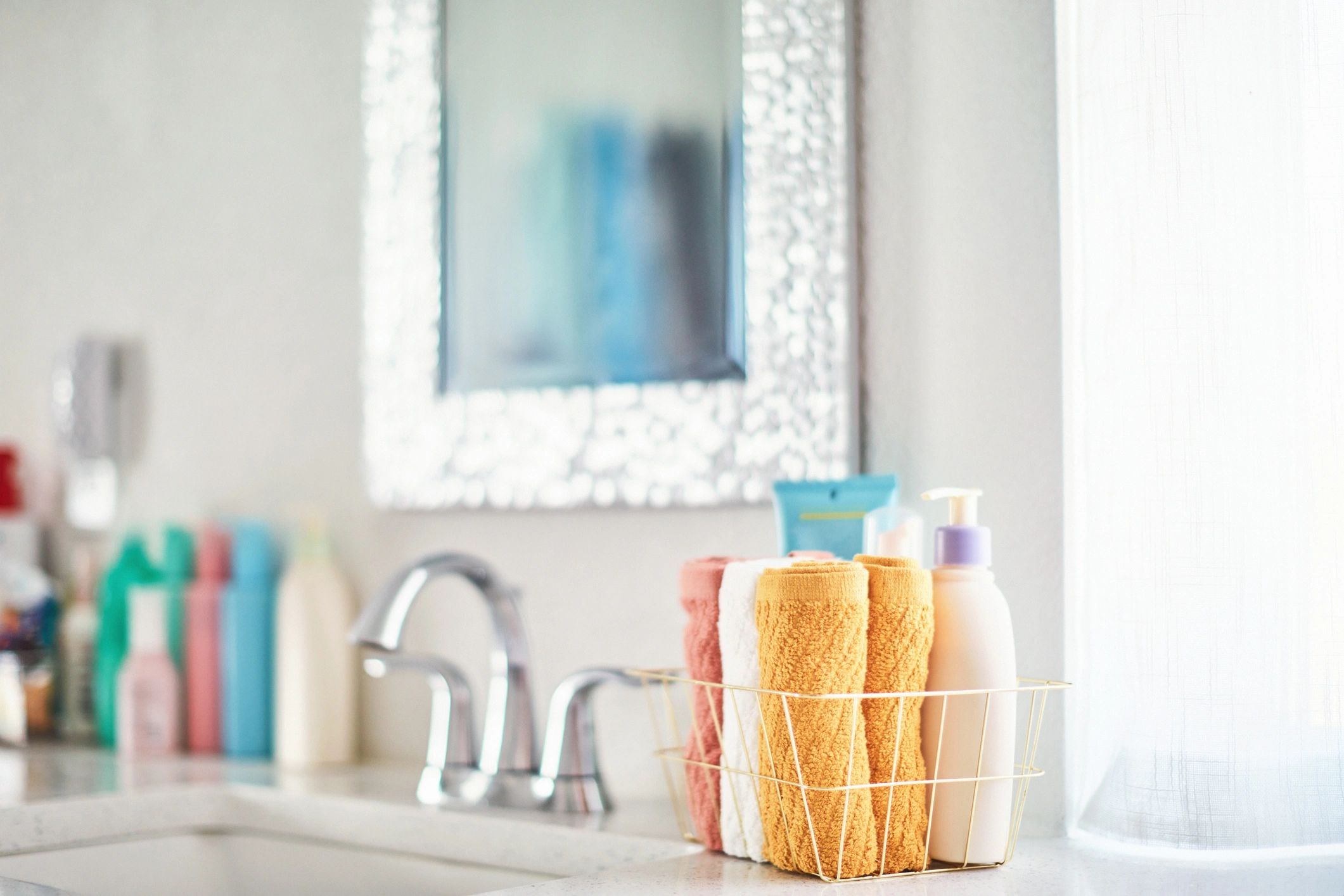 Bright modern bathroom with basket of towels