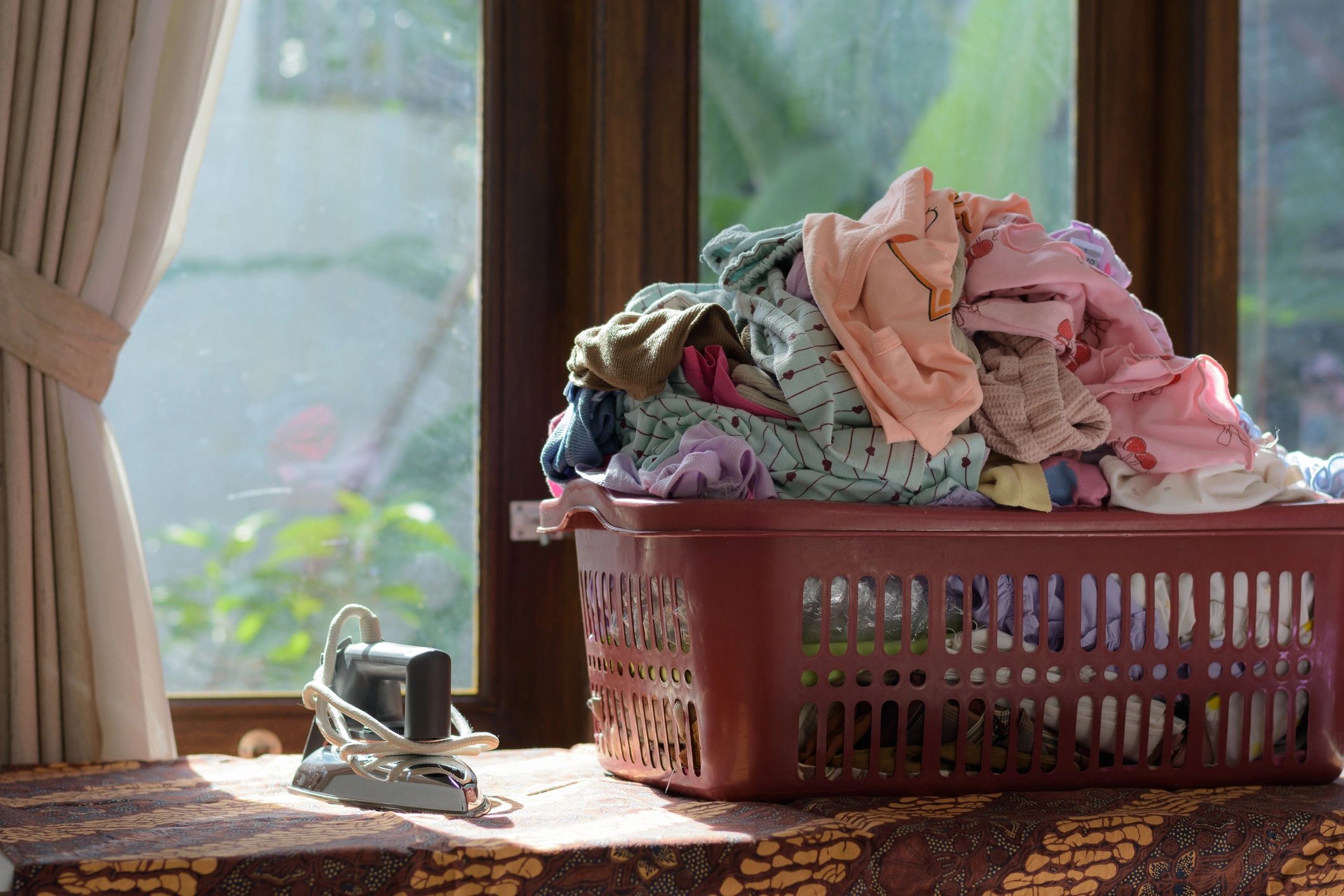 Laundry basket by a bright window representing laundry swaps